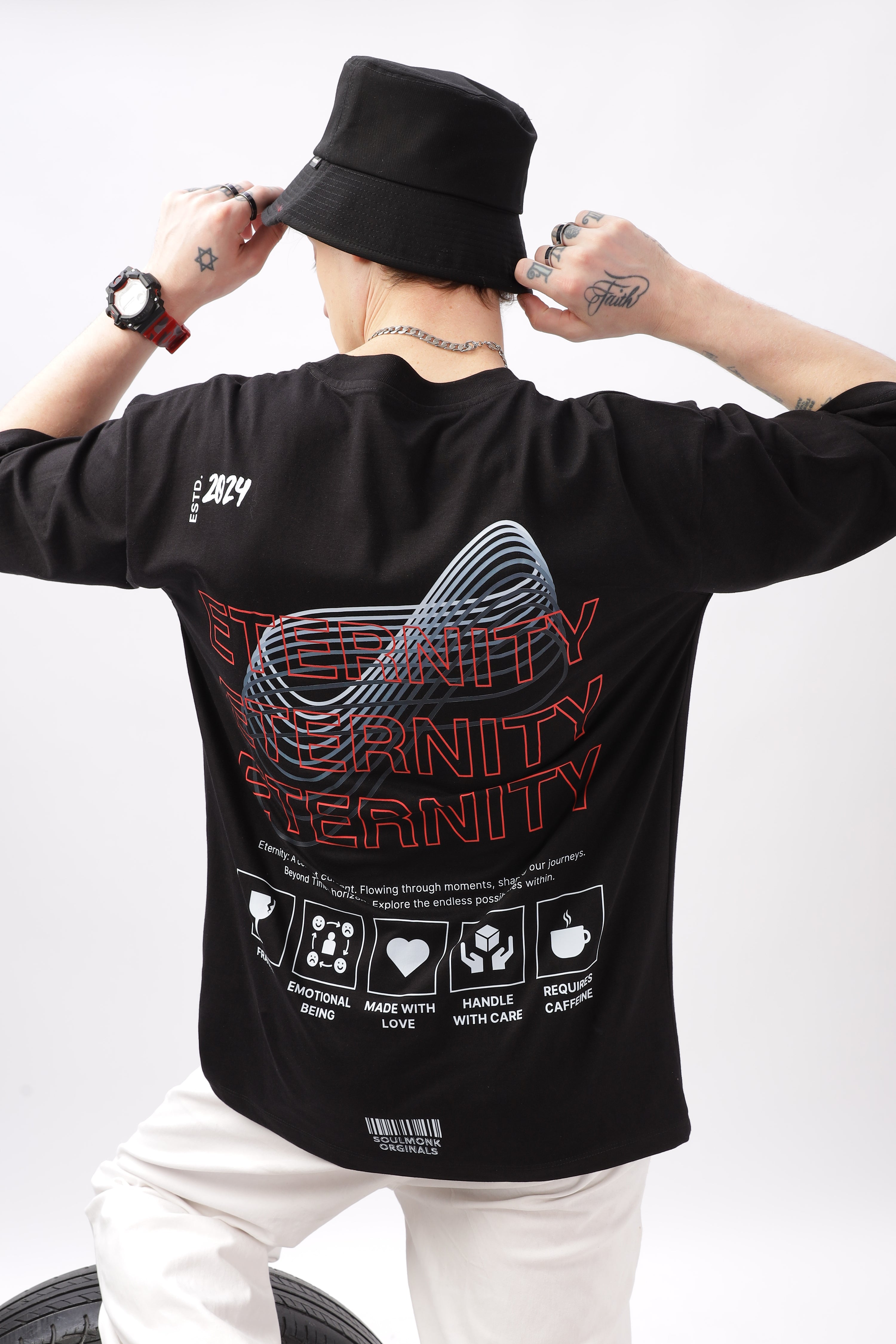 Back view of man wearing black Eternity Oversized T-Shirt Collection Men with bold graphic print and relaxed fit