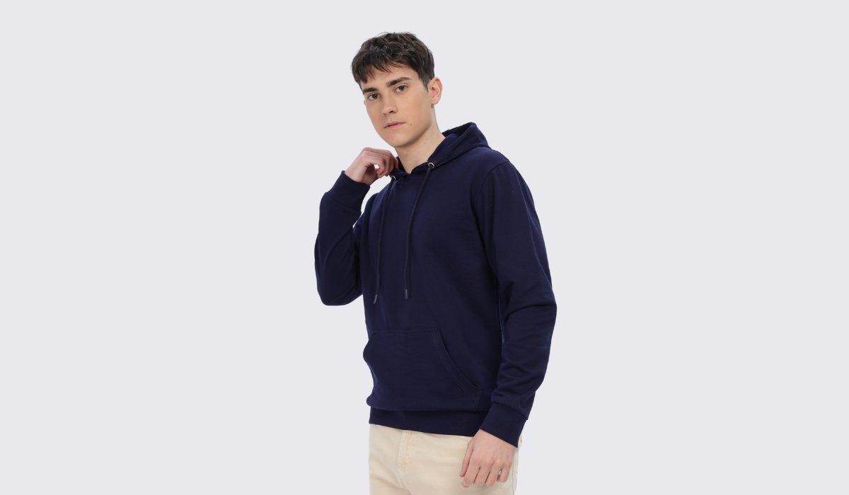 Young man wearing a navy blue Soulmonk hoodie showcasing comfort and style from the hoodies and crop hoodies collection