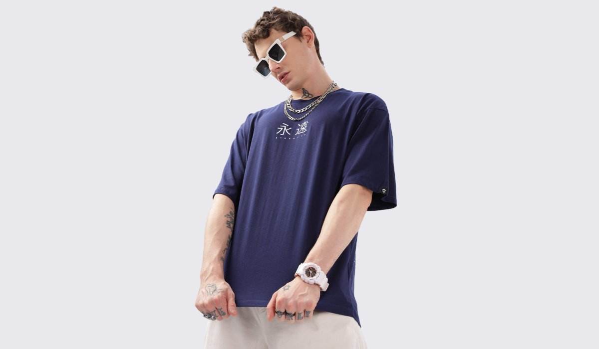 Model wearing a navy blue oversized t shirt for men and wowen with white graphic and casual streetwear style