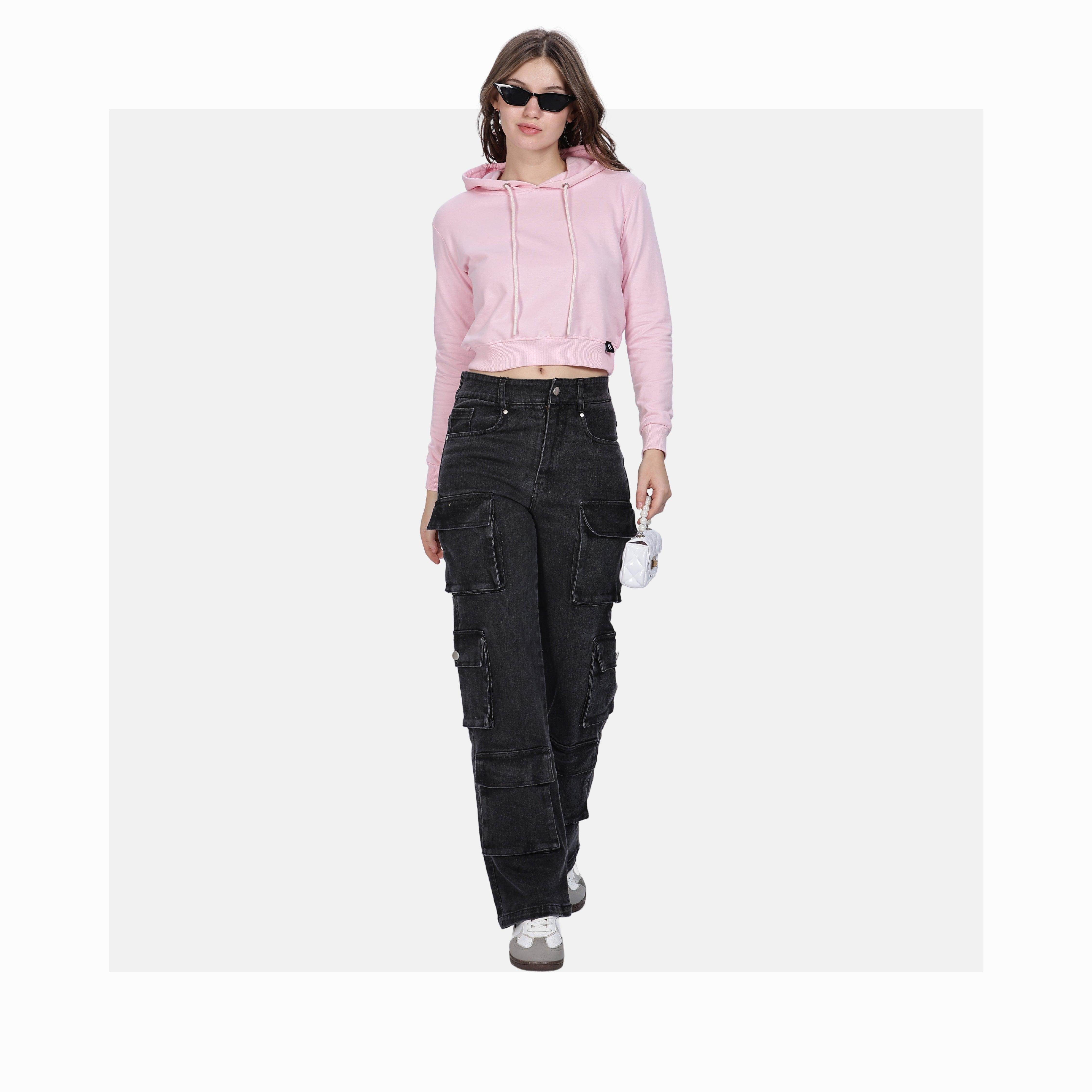 Woman wearing soft pink women's crop hoodies paired with black cargo pants and sunglasses