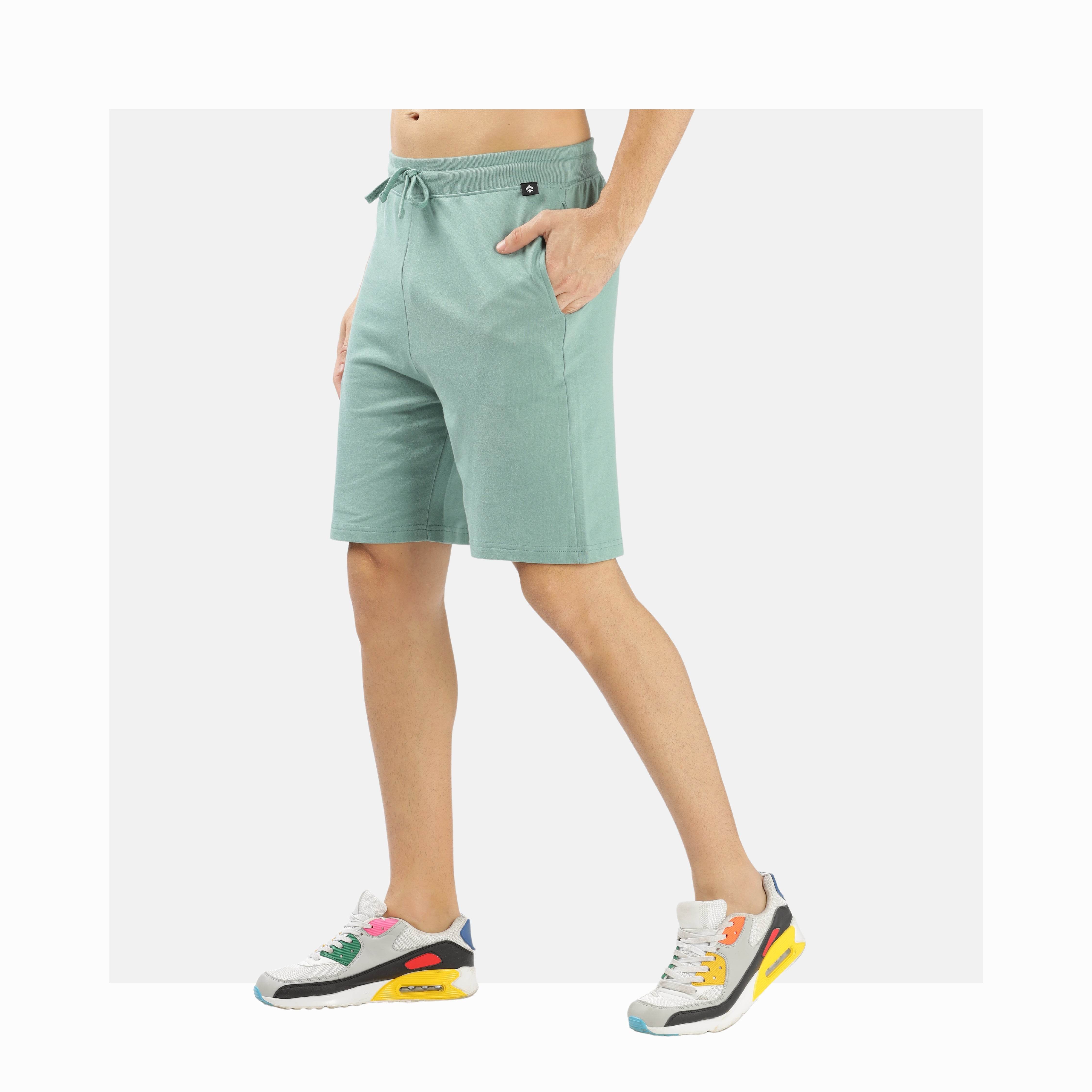 Unisex Soulmonk premium comfort shorts in light green worn with colorful sneakers for casual style