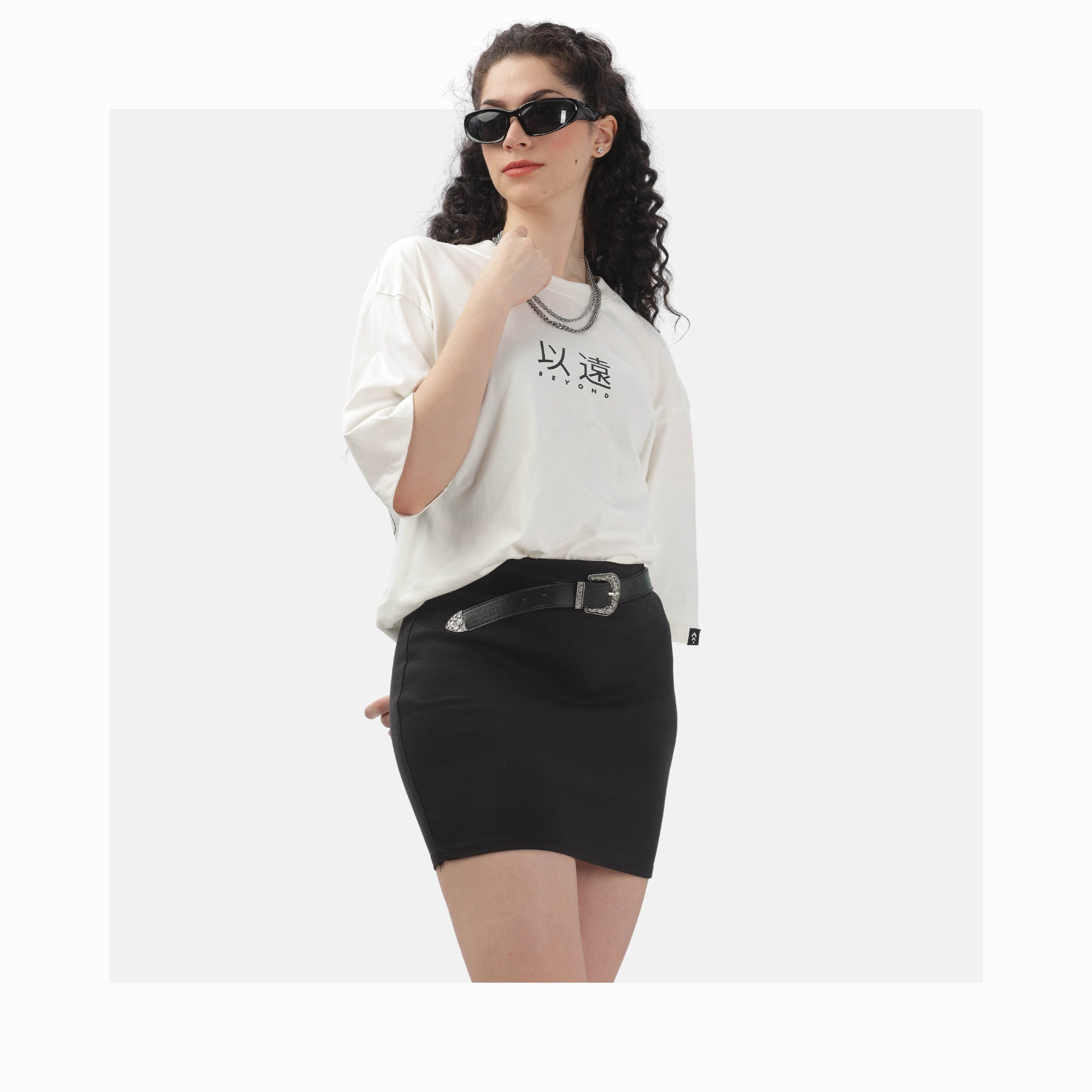 Woman wearing oversized white tee and black skirt showcasing versatile tees and tops for her collection
