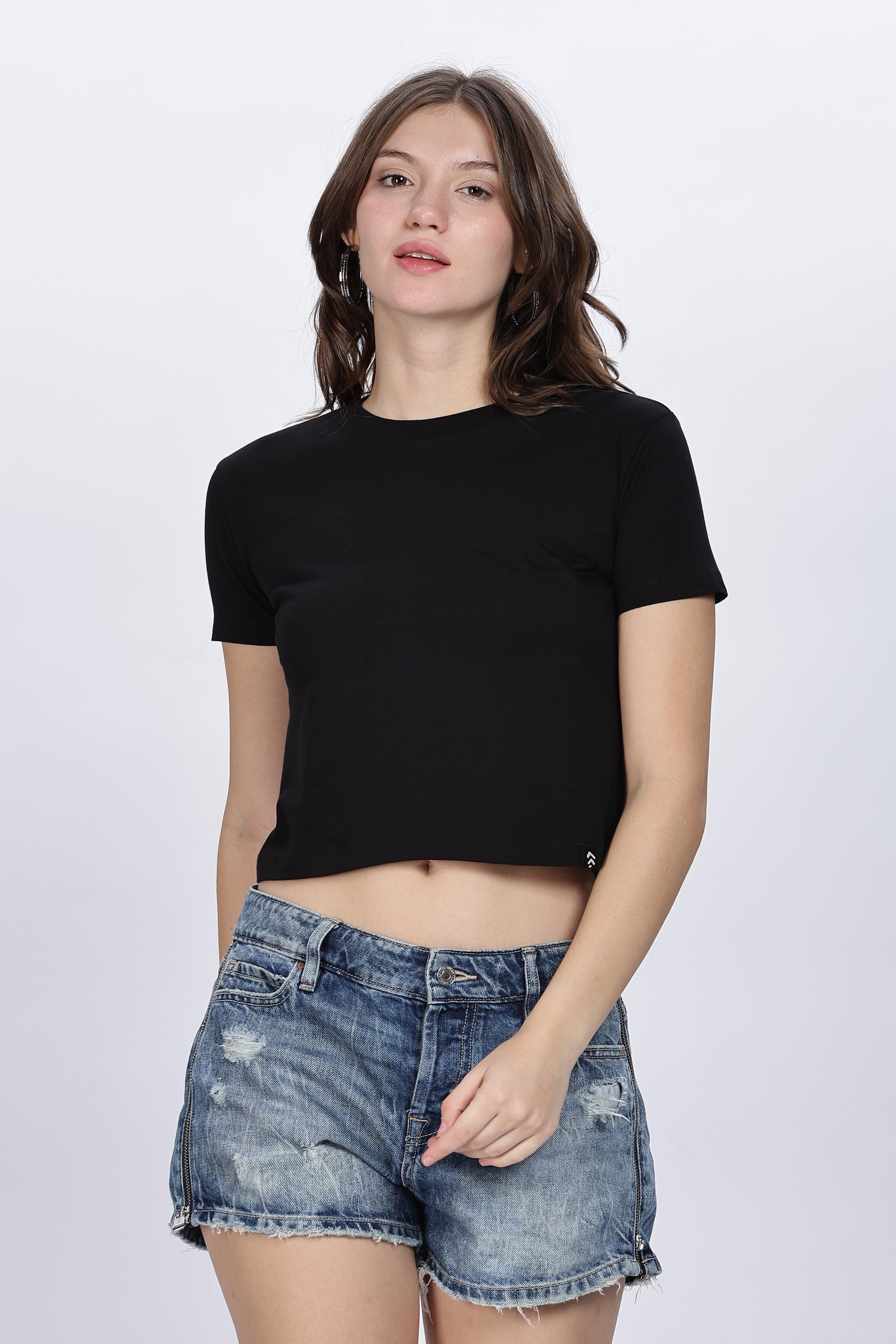 Soulmonk black solid crop top worn by female model paired with distressed denim shorts