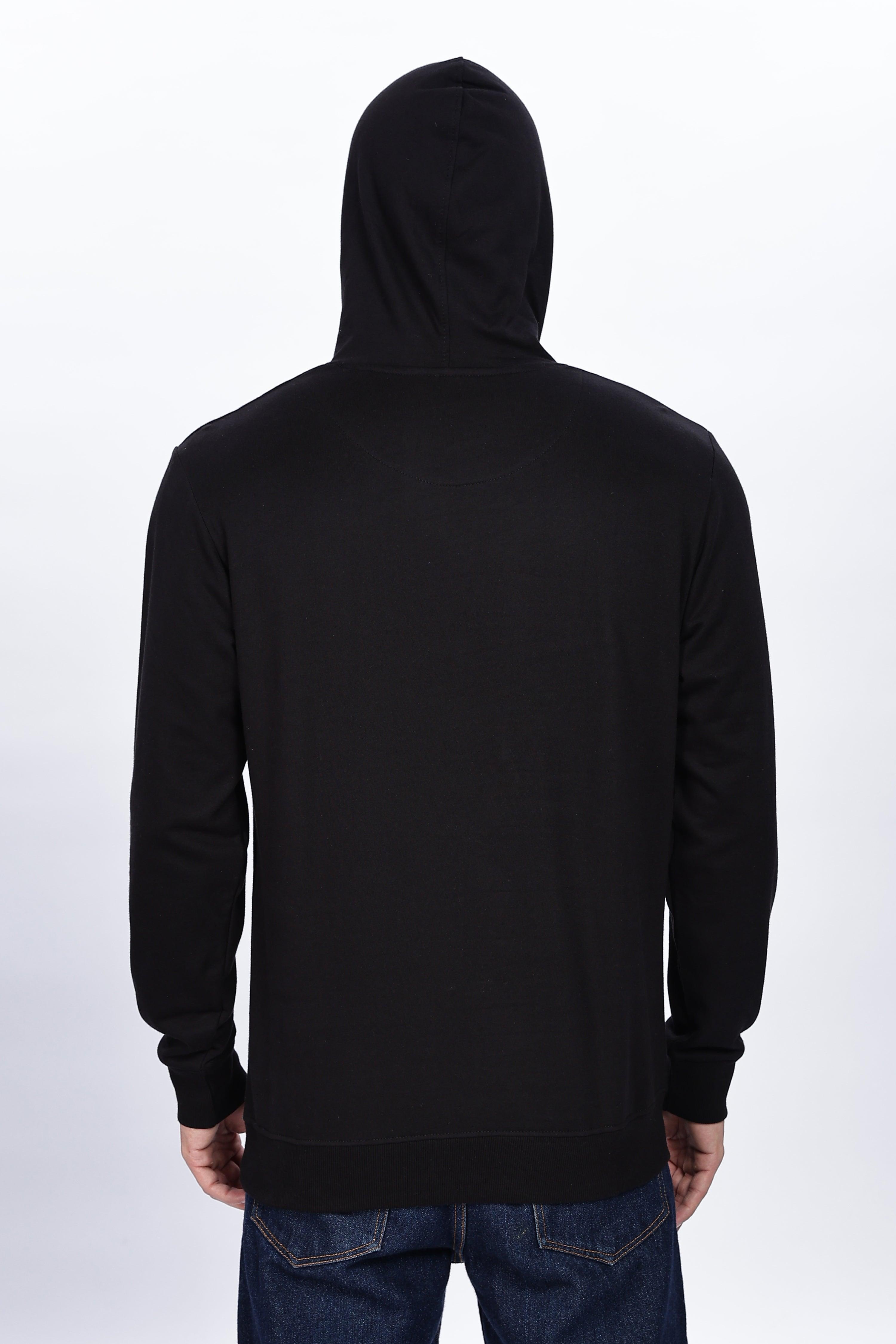 Male model wearing Soulmonk midnight black hoodie shown from the back with hood up
