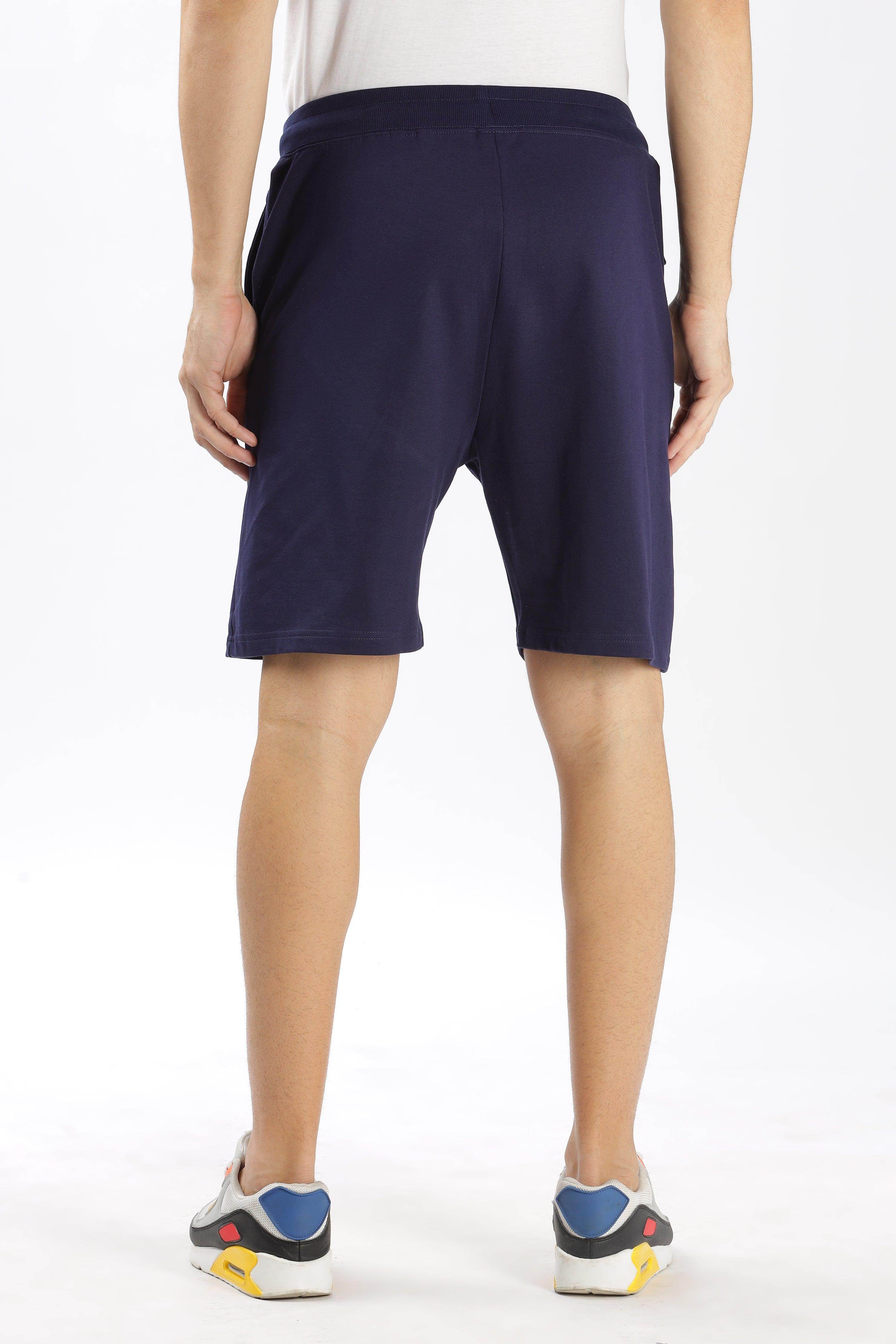 SoulMonk navy blue shorts shown from the back on a male model wearing white shirt and sneakers
