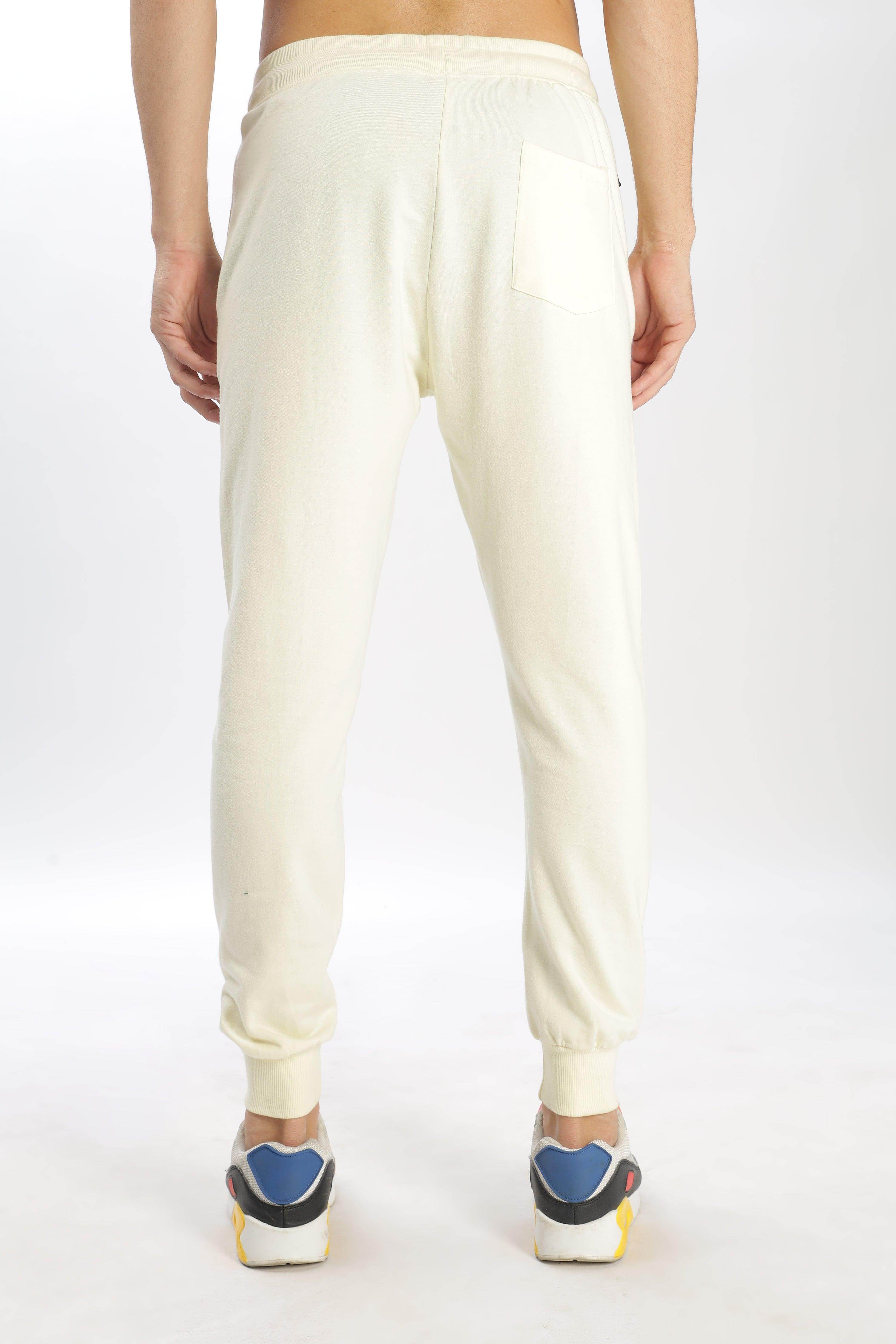 Soulmonk pear sorbet joggers in light cream color shown from back with pocket and cuffed ankles