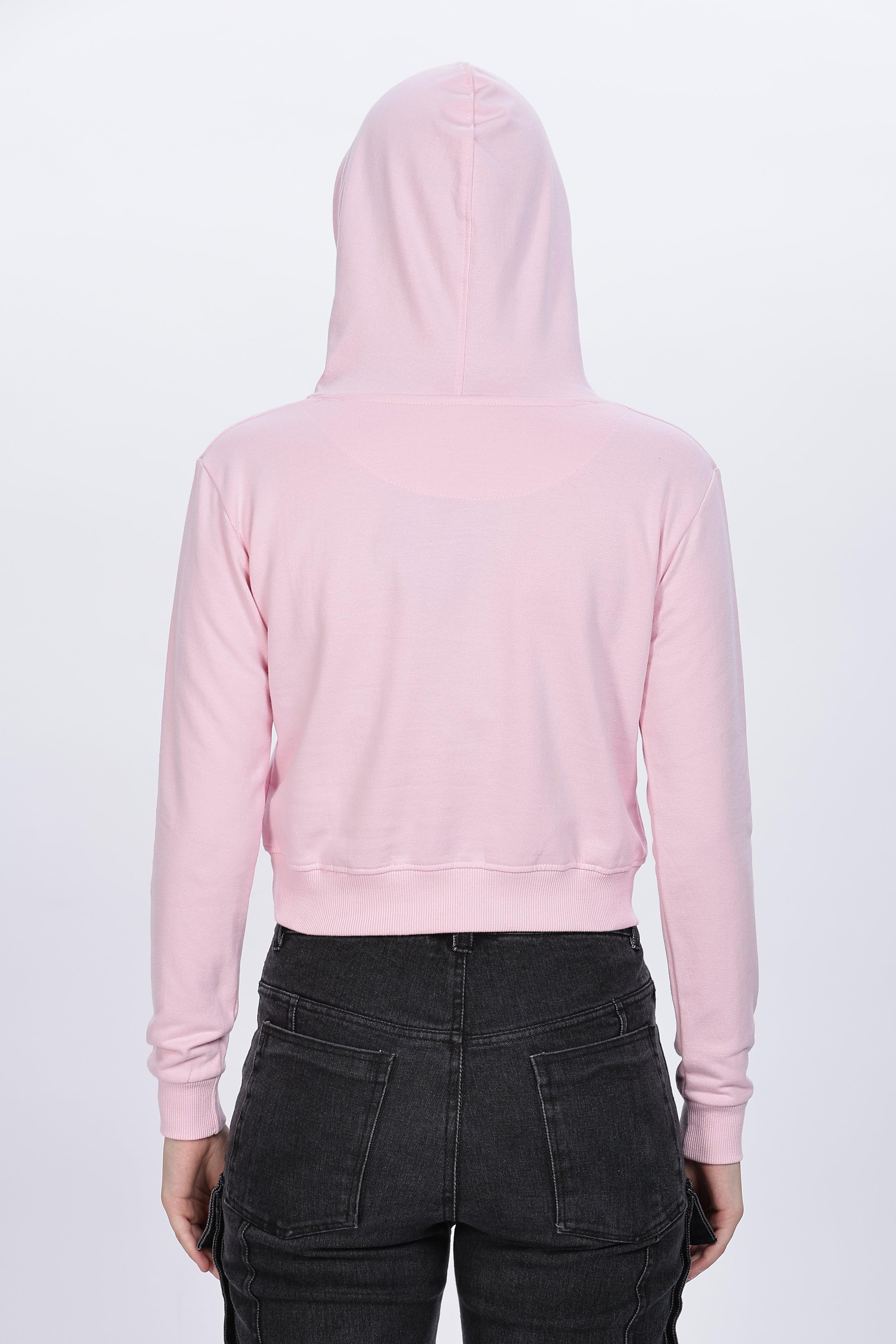 Soulmonk soft pink crop hoodie worn by female model shown from back with black pants