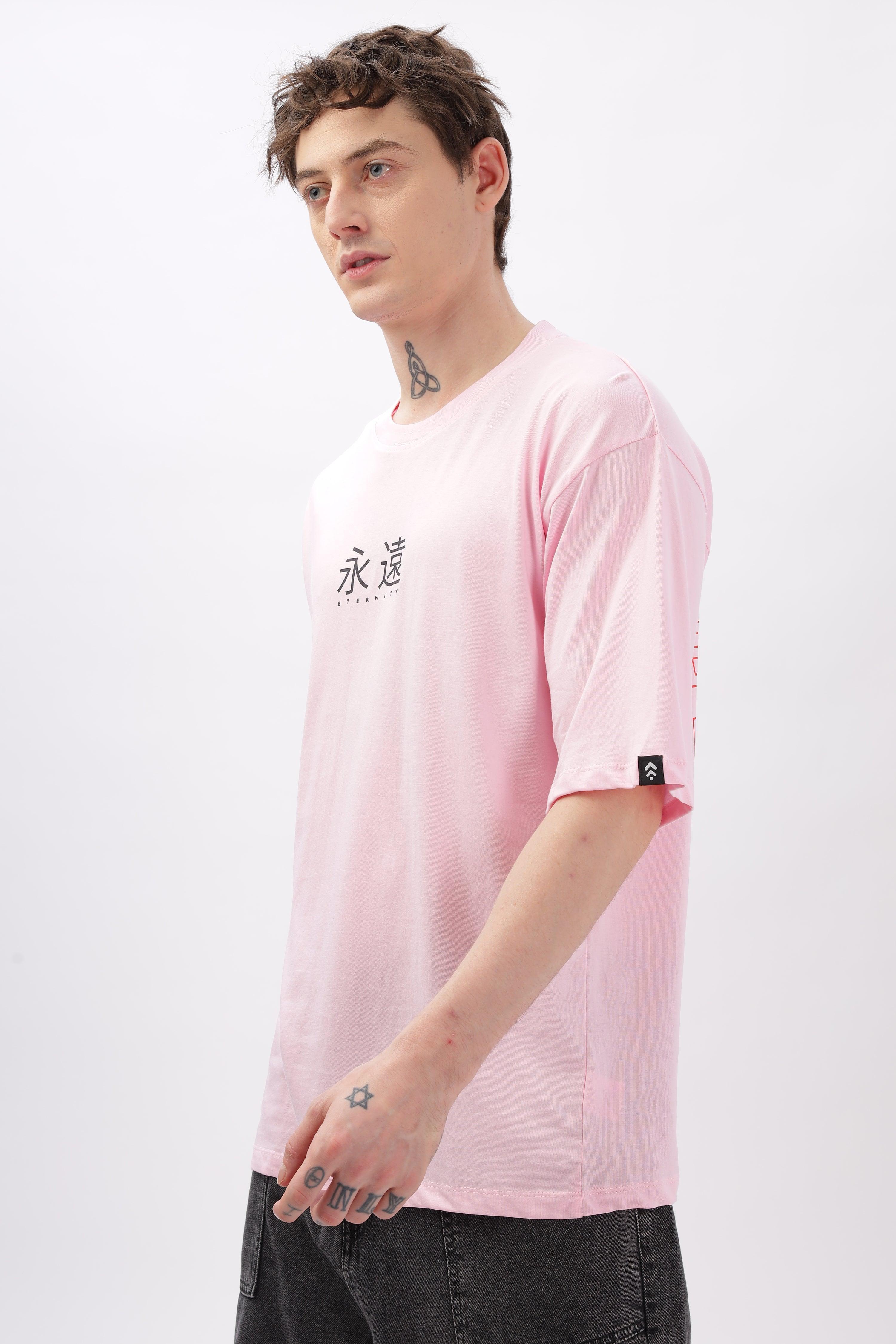 Soulmonk male model wearing a soft pink oversized t-shirt with black text detail on front