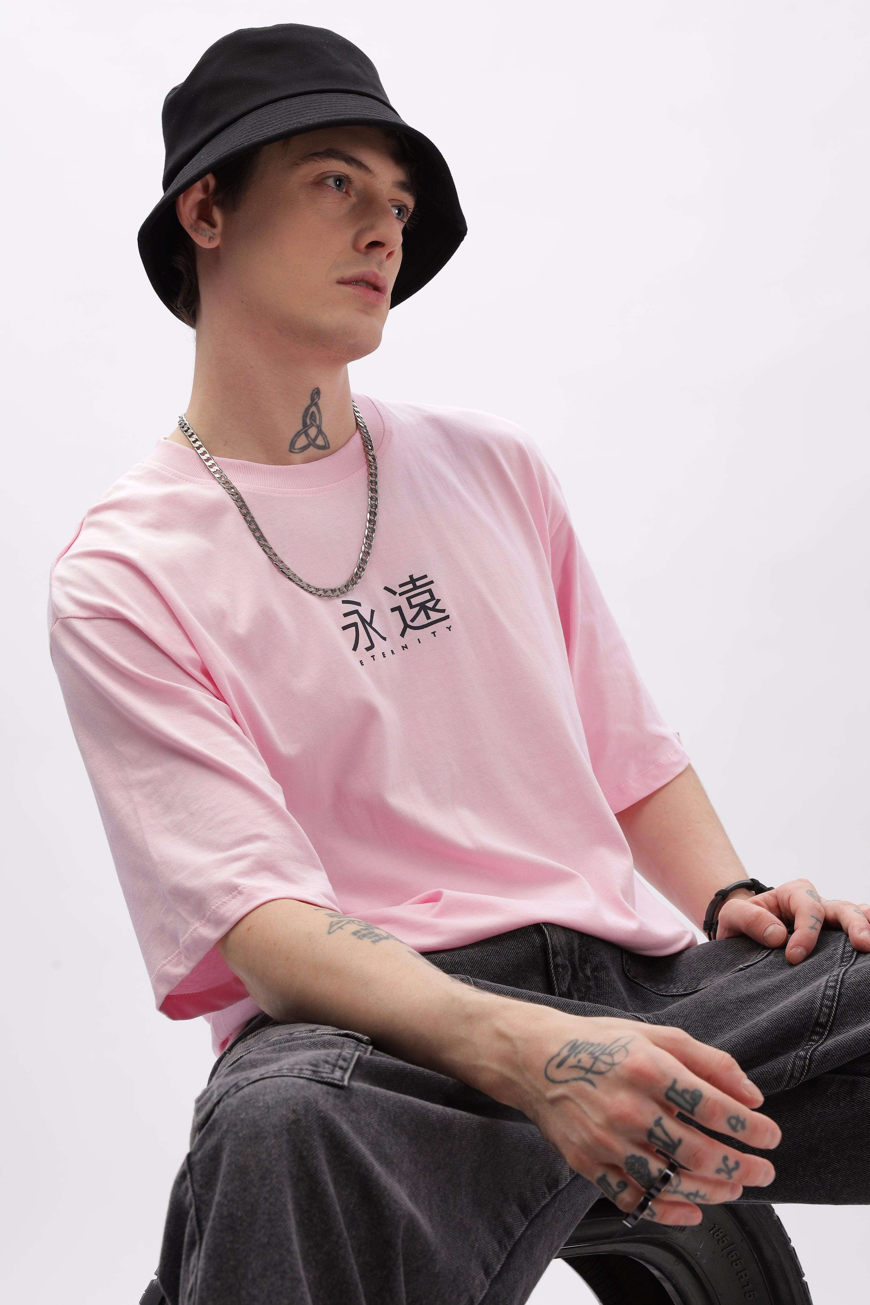 Male model wearing Soulmonk soft pink oversized t-shirt with black bucket hat and chain necklace