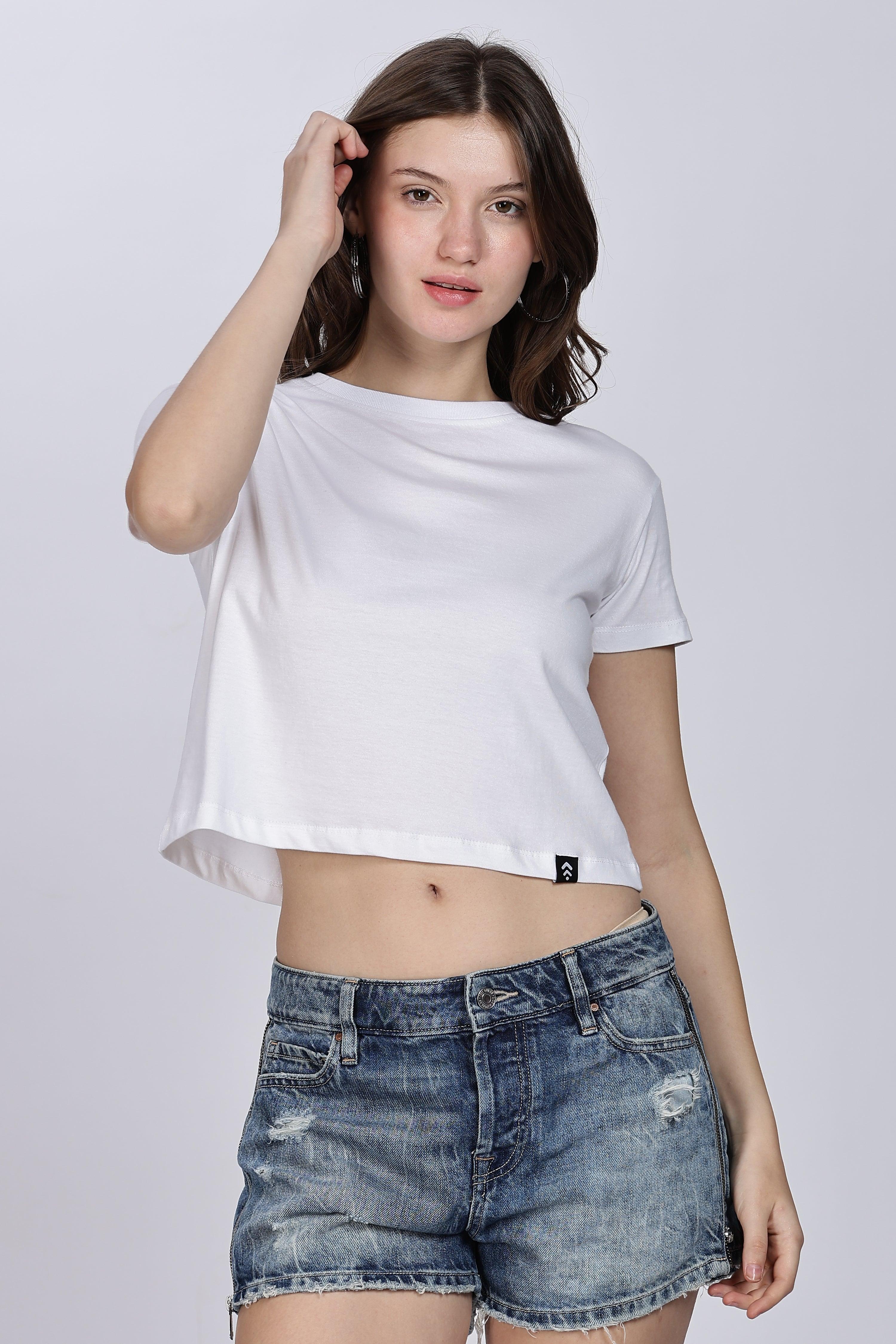Woman wearing Soulmonk white crop top for women paired with distressed denim shorts