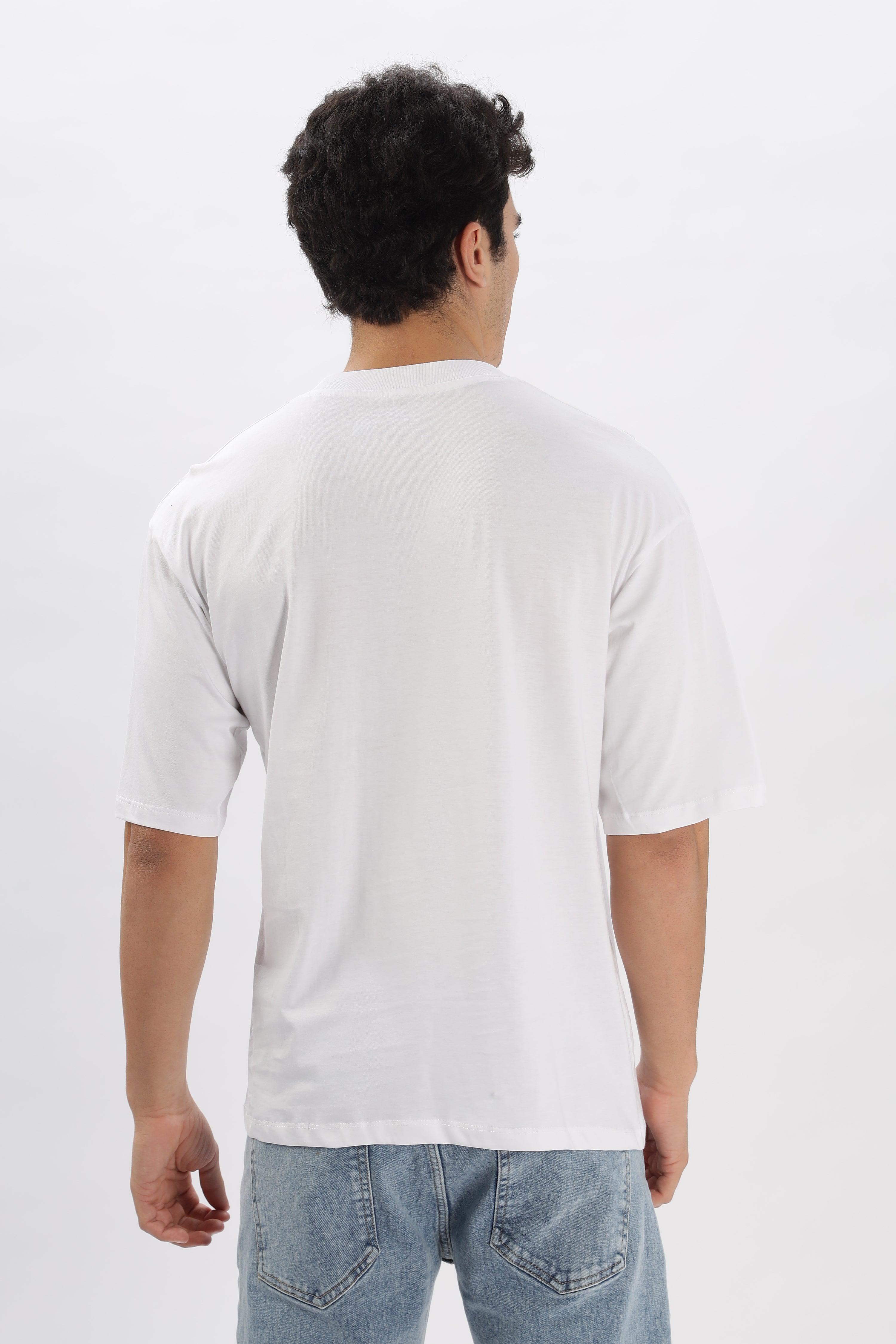 Back view of a male model wearing a white oversized t-shirt for men paired with light blue jeans