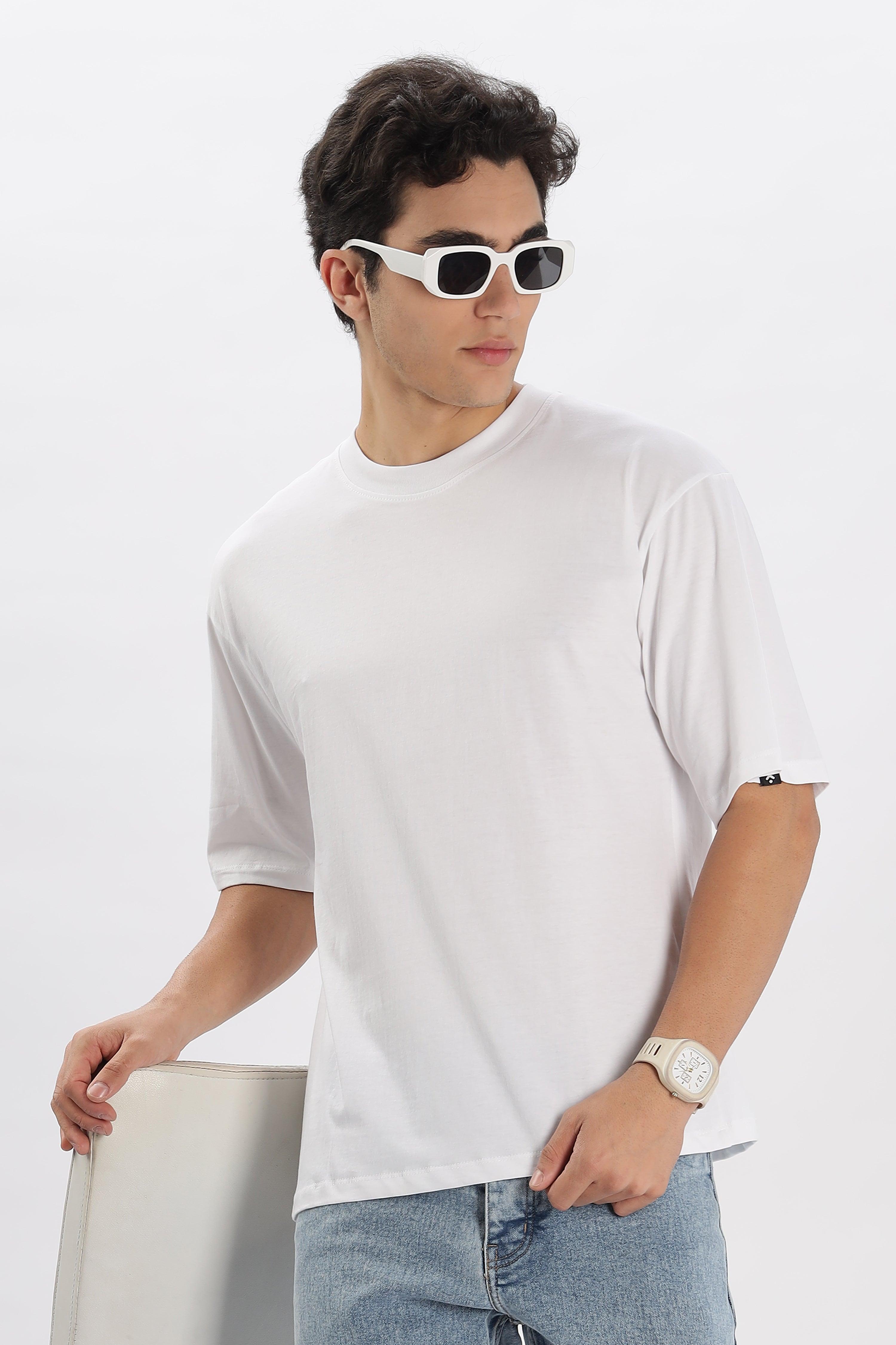 Male model wearing a white oversized t-shirt for men from Soulmonk paired with light blue jeans and white sunglasses