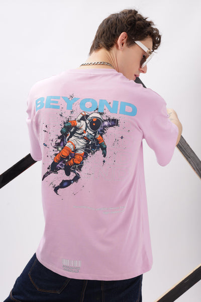 Male model wearing Soulmonk oversized lilac t-shirt with astronaut graphic and Beyond text