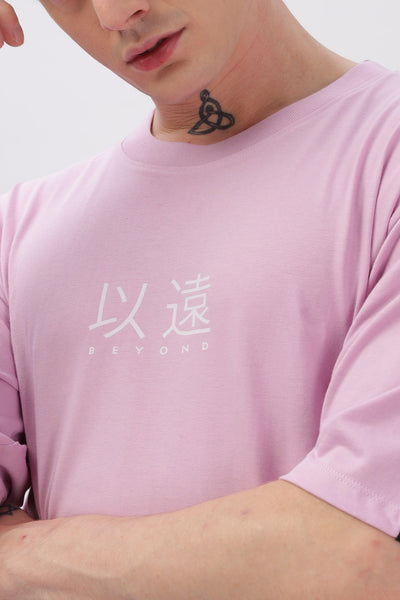 Male model wearing oversized lilac t-shirt with white Japanese characters and beyond text