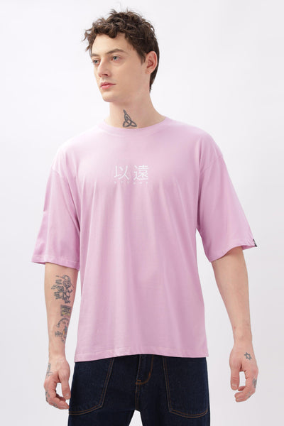 Male model wearing Soulmonk oversized lilac t-shirt with white graphic text and relaxed fit