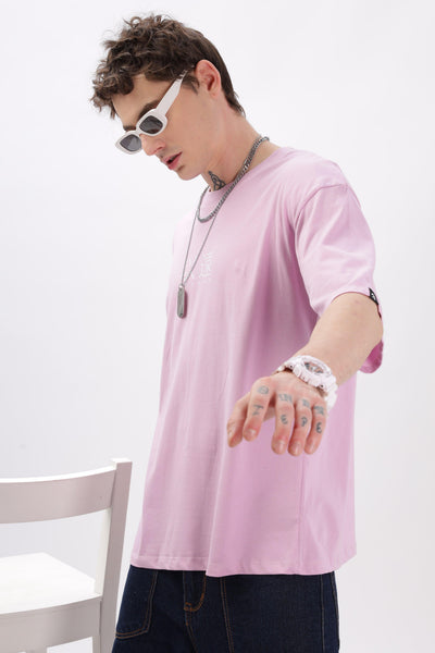 Male model wearing oversized lilac t-shirt by Soulmonk with white sunglasses and dark pants