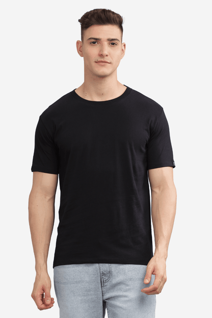 Black relaxed fit t-shirt men modeled by man wearing light blue jeans by Soulmonk