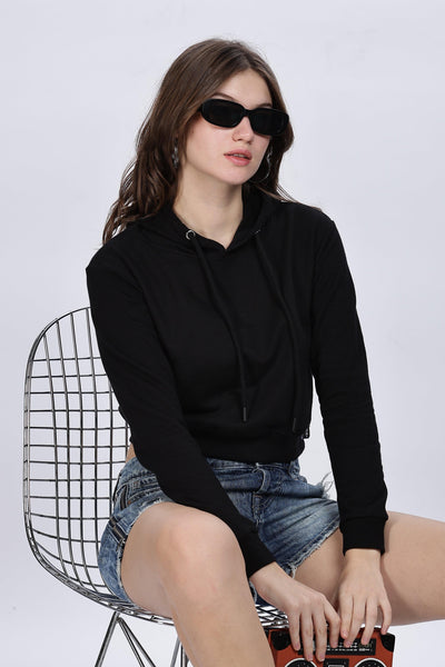 Soulmonk black crop hoodie for women worn with denim shorts and black sunglasses