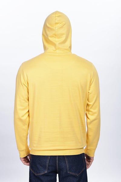 Back view of male wearing golden yellow hoodie by Soulmonk with hood up and casual fit