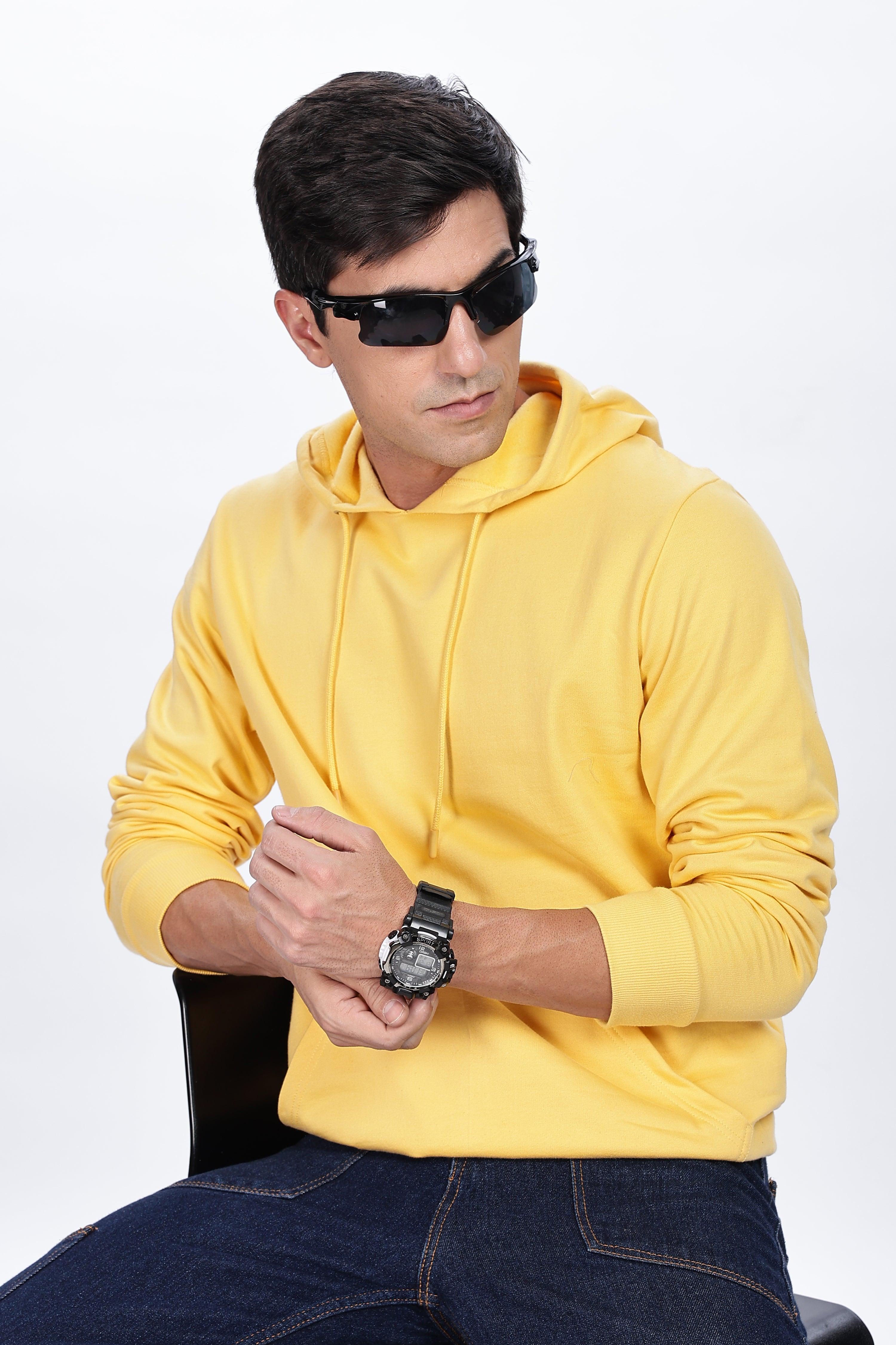 Male model wearing a Soulmonk golden yellow hoodie with drawstrings and long sleeves