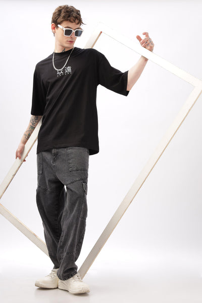 Soulmonk oversized black t-shirt for men worn by male model with sunglasses and grey cargo pants