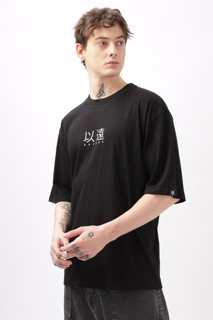 Soulmonk oversized black t-shirt for men worn by male model with tattoos and short hair