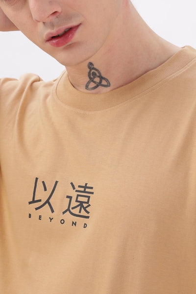Male model wearing Soulmonk oversized taupe t-shirt with black beyond graphic on chest