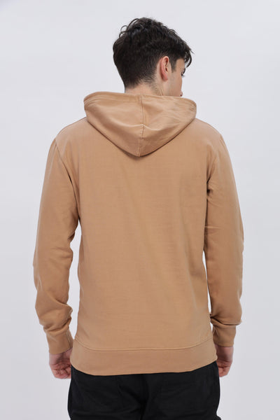 Back view of male model wearing caramel brown hoodie by Soulmonk with hood up and long sleeves