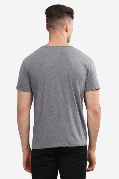 Male model wearing a dark grey relaxed fit t-shirt by Soulmonk, shown from the back