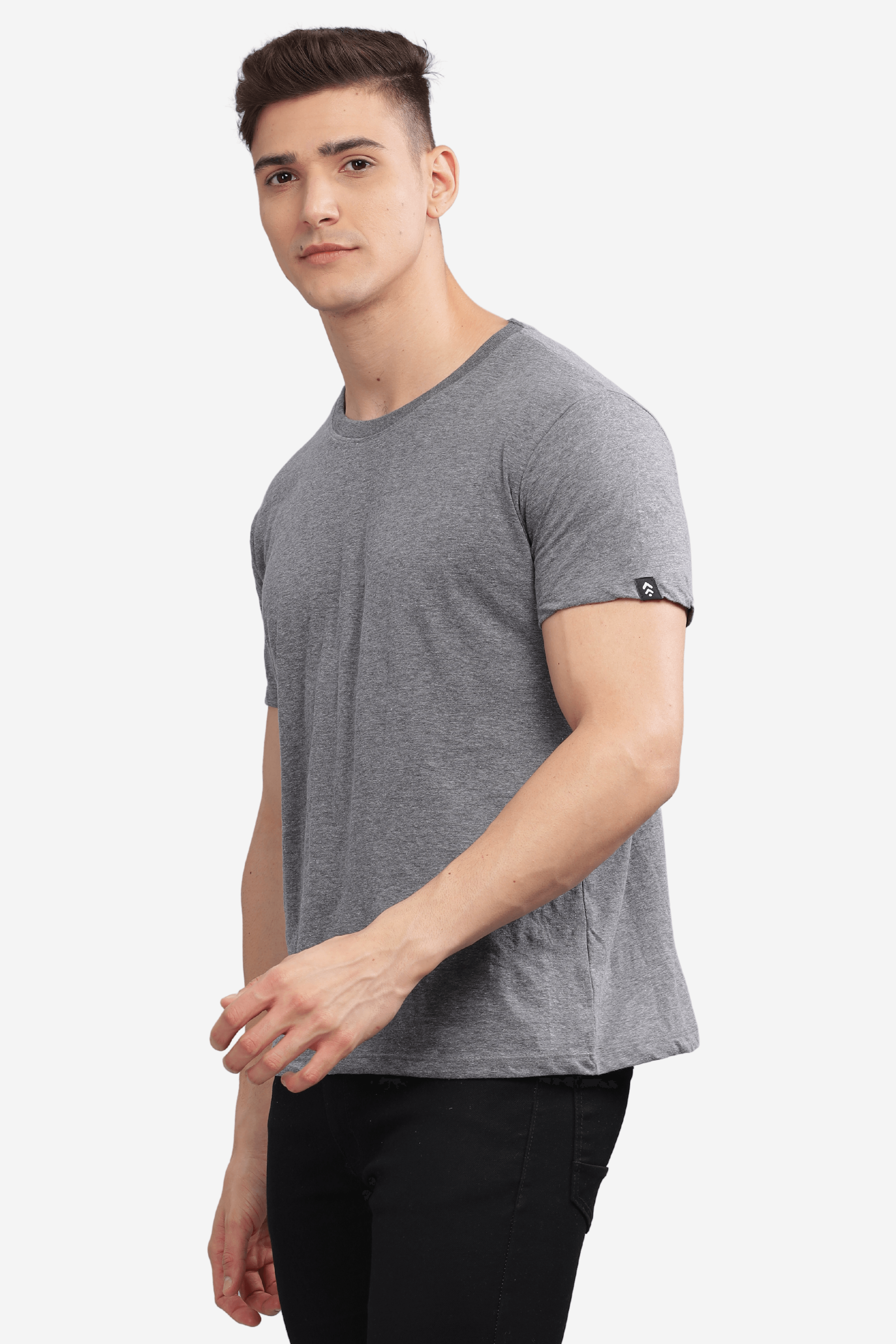 Male model wearing a dark grey relaxed fit t-shirt by Soulmonk paired with black pants