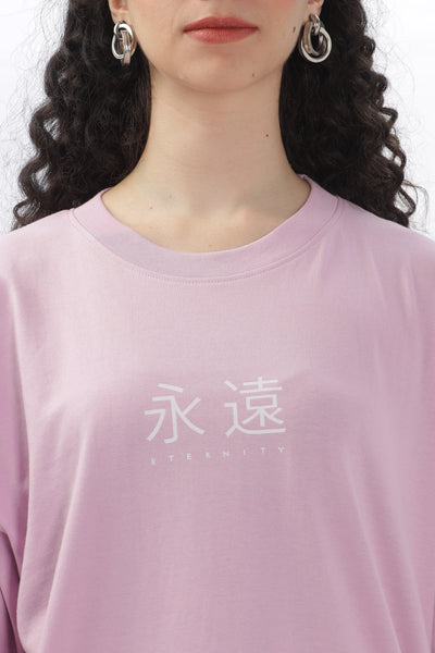 Female model wearing a Soulmonk lavender oversized t-shirt with white graphic text on the front