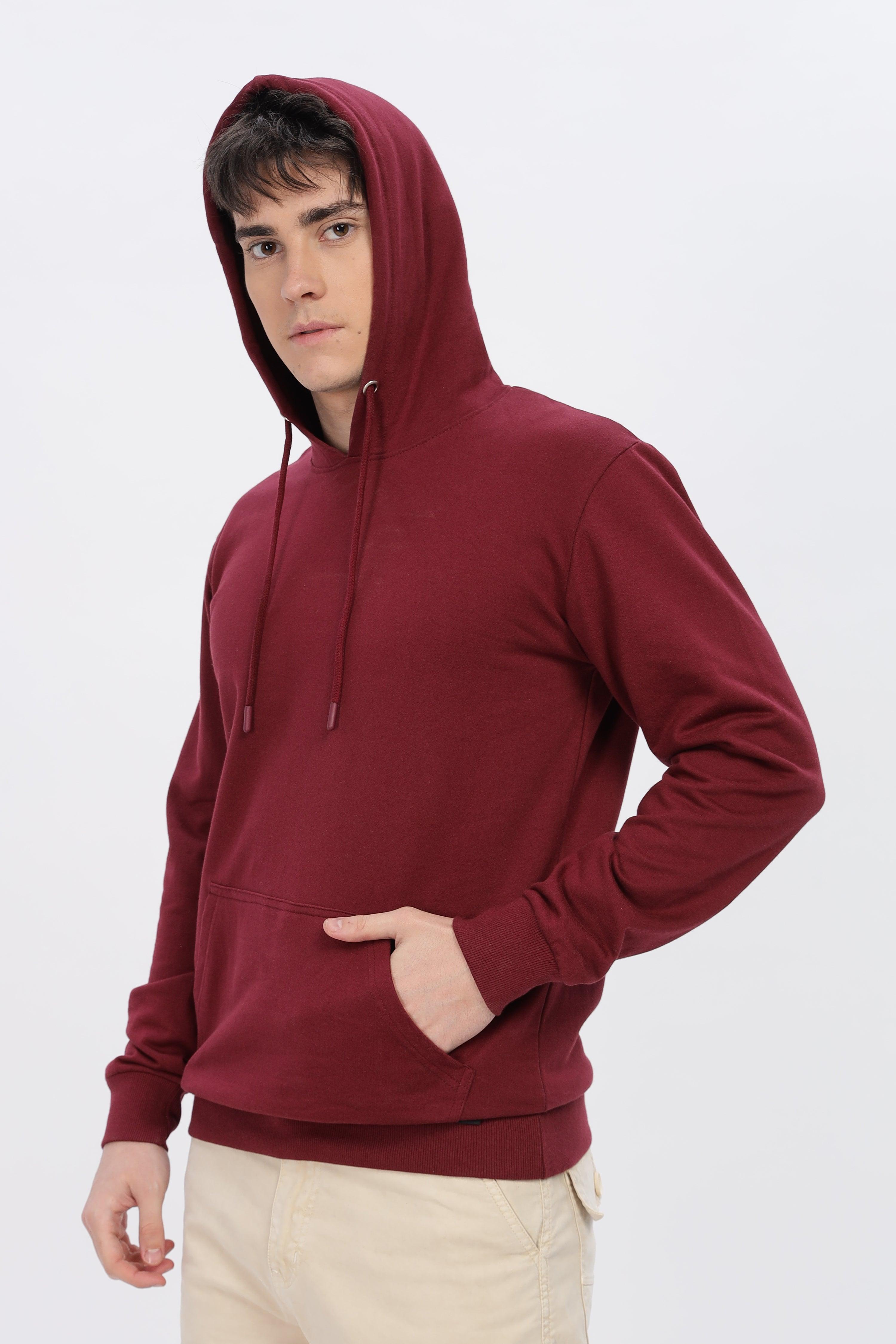 Male model wearing maroon solid hoodie with front pocket and hood by Soulmonk