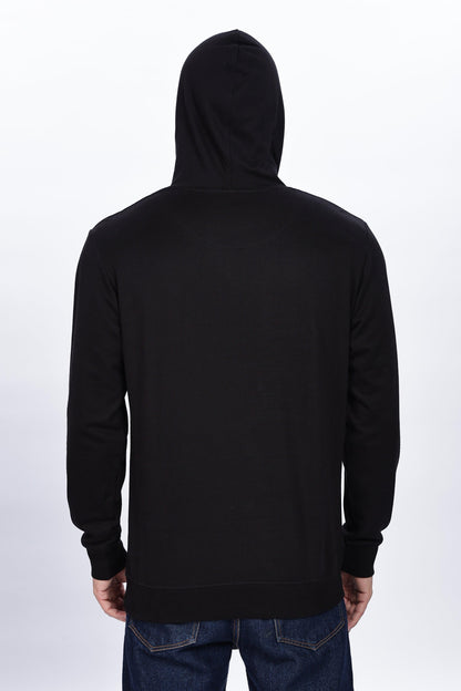 Male model wearing Soulmonk midnight black hoodie shown from the back with hood up