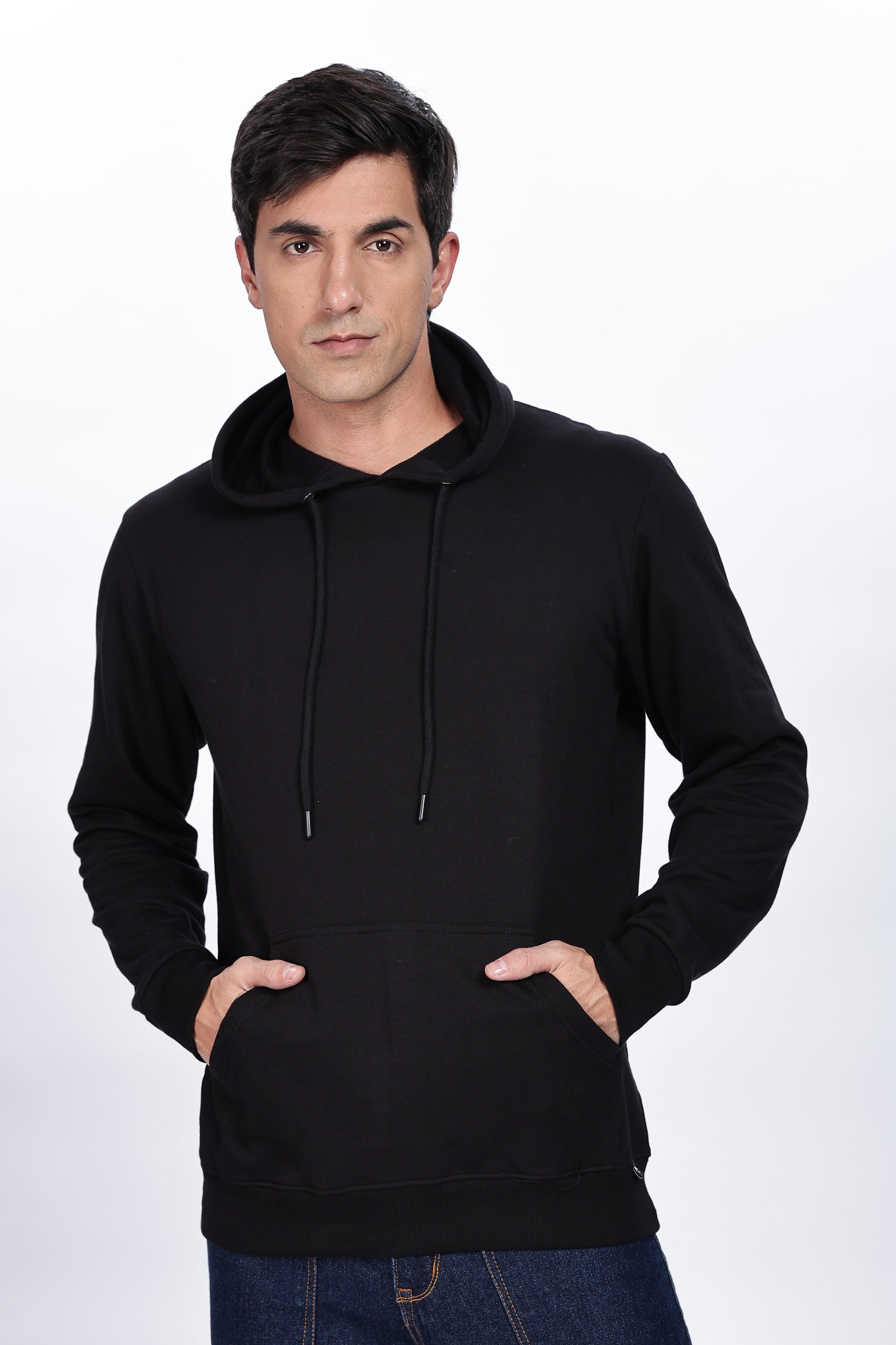 Male model wearing Soulmonk midnight black hoodie with front pockets and drawstring hood