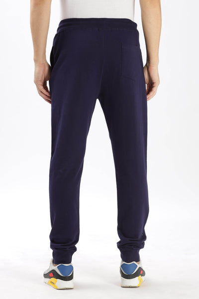 Soulmonk navy blue joggers for men shown from the back with elastic waistband and cuffed ankles