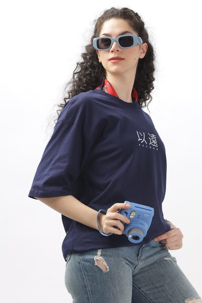 Soulmonk female model wearing navy blue oversized t-shirt with white print and distressed jeans