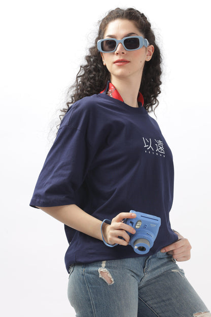 Soulmonk female model wearing navy blue oversized t-shirt with white print and distressed jeans