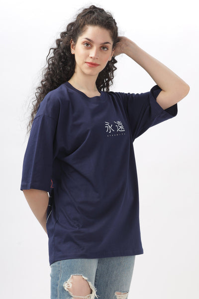 Soulmonk navy blue oversized t-shirt worn by woman with curly hair paired with ripped jeans
