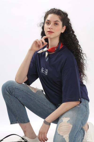 Soulmonk navy blue oversized t-shirt worn by female model paired with ripped jeans and scarf