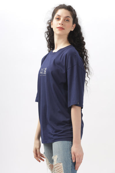 Soulmonk navy blue oversized t-shirt worn by female model with curly hair and ripped jeans