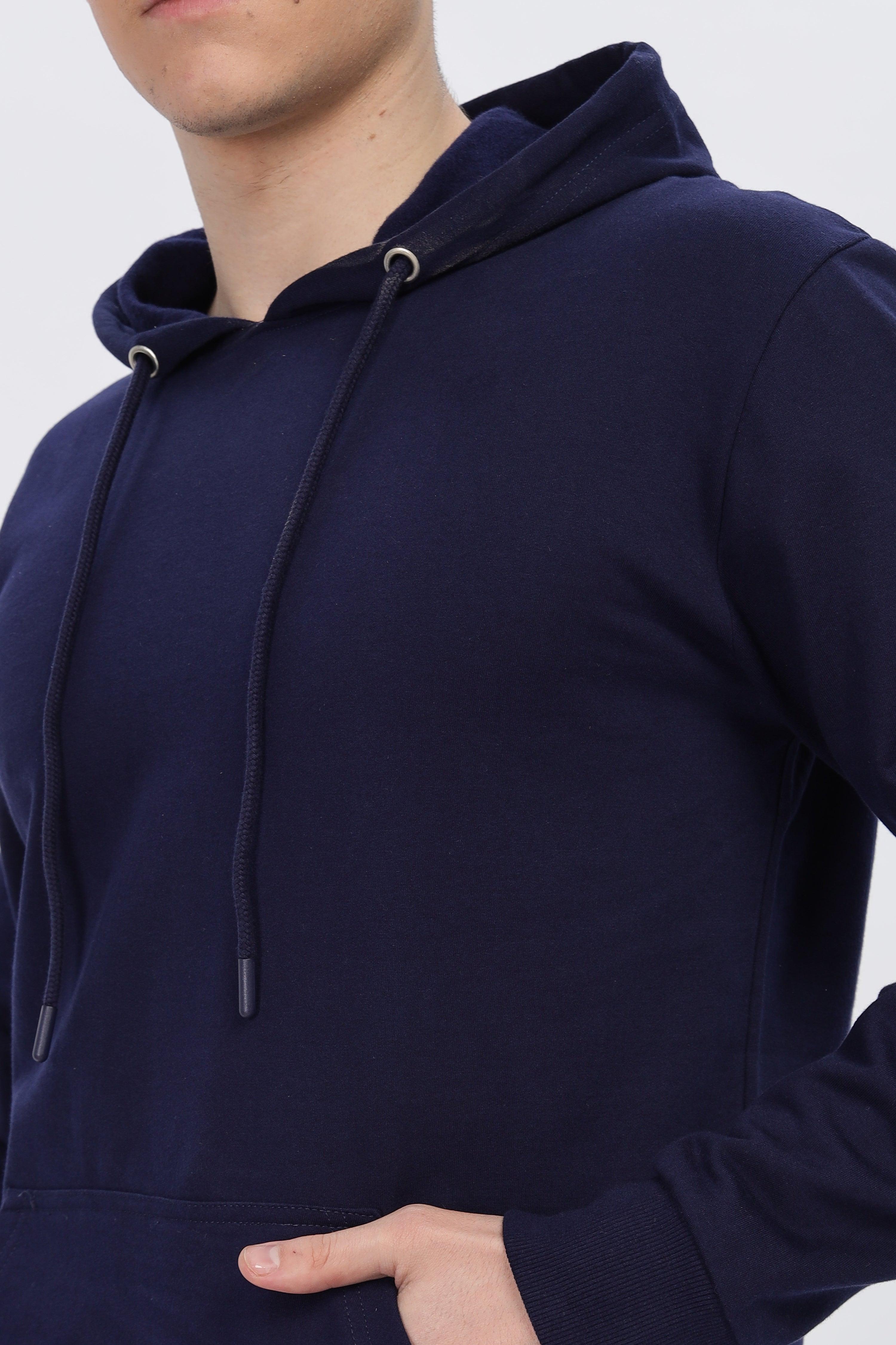 Male model wearing navy blue solid hoodie from Soulmonk with drawstring hood and front pocket