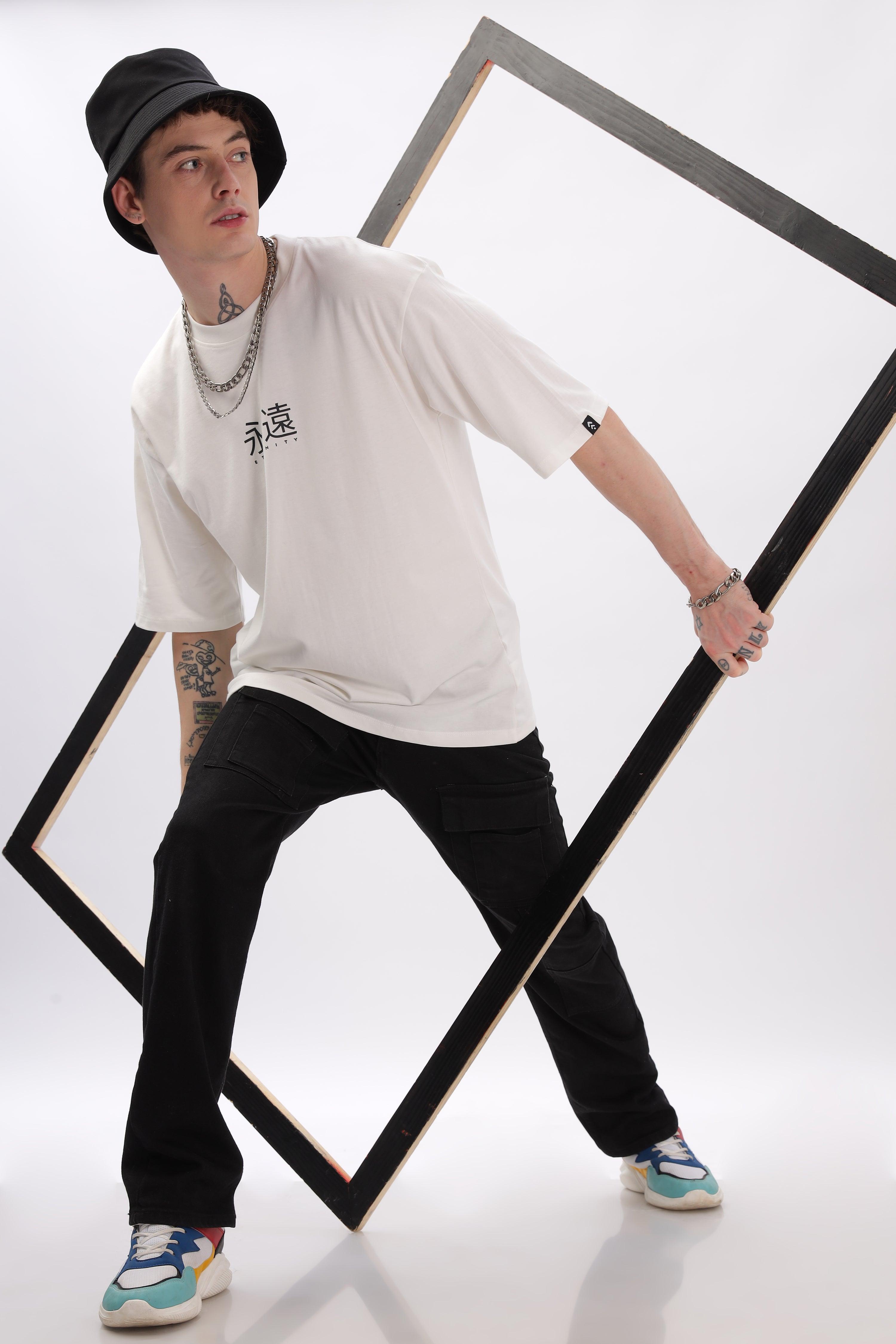 Male model wearing Soulmonk off-white oversized t-shirt with black pants and bucket hat