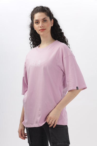 Soulmonk female model wearing oversized lavender t-shirt with subtle front graphic and relaxed fit