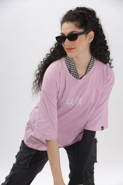 Soulmonk oversized lavender t-shirt worn by a woman with black sunglasses and curly hair