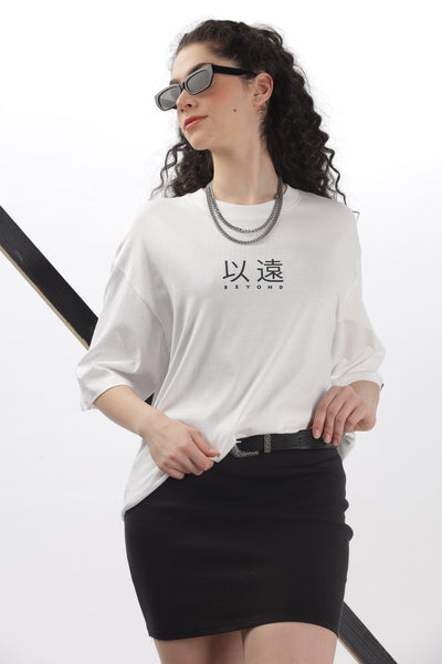 Soulmonk oversized white t-shirt women with black graphic text styled with black skirt and sunglasses