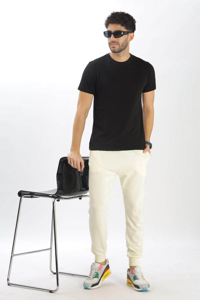 Soulmonk pear sorbet joggers worn by male model with black t-shirt and colorful sneakers