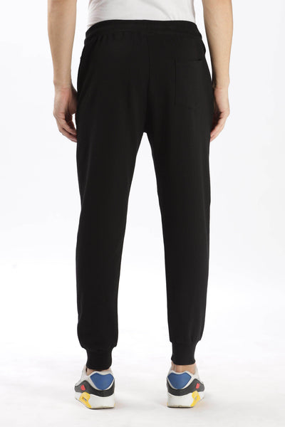 Soulmonk premium black joggers men shown from the back with elastic waistband and cuffed ankles