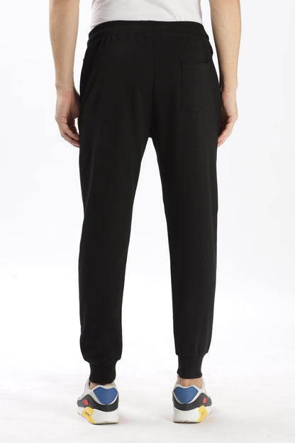 Soulmonk premium black joggers men shown from the back with elastic waistband and cuffed ankles