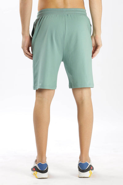 Soulmonk sage green shorts with elastic waistband worn by male model from back