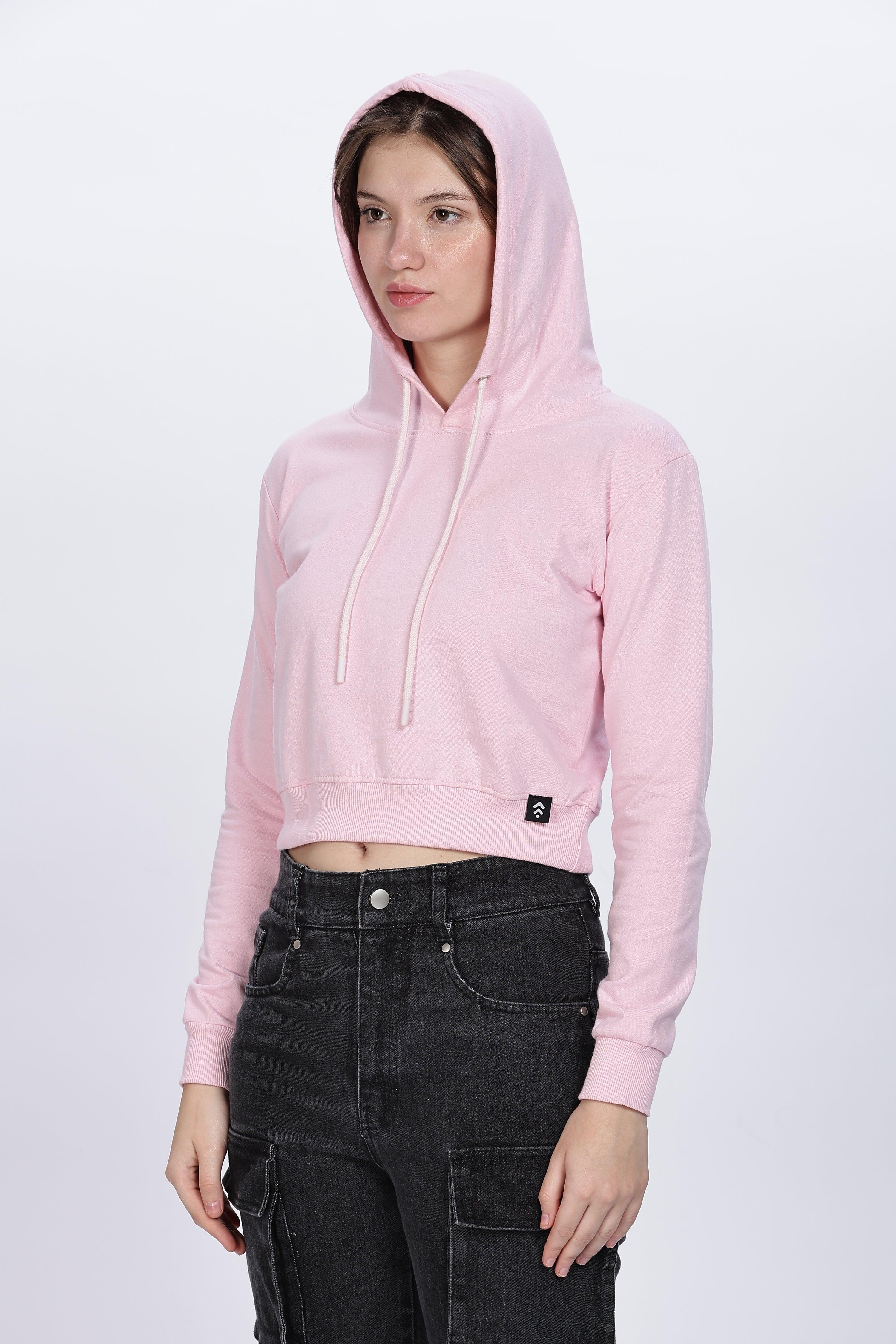 Soulmonk soft pink crop hoodie worn by female model with hood up and black cargo pants